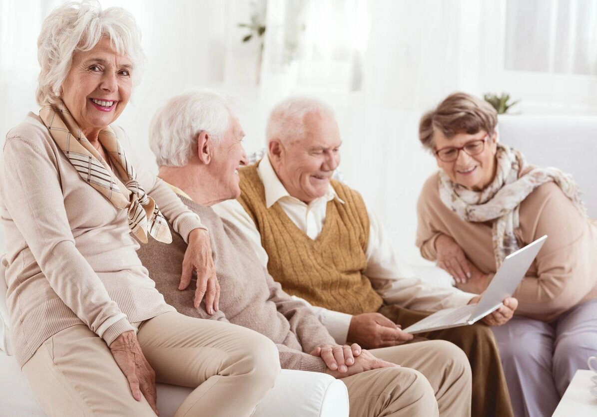 Elderly friends enjoying time together indoors.
